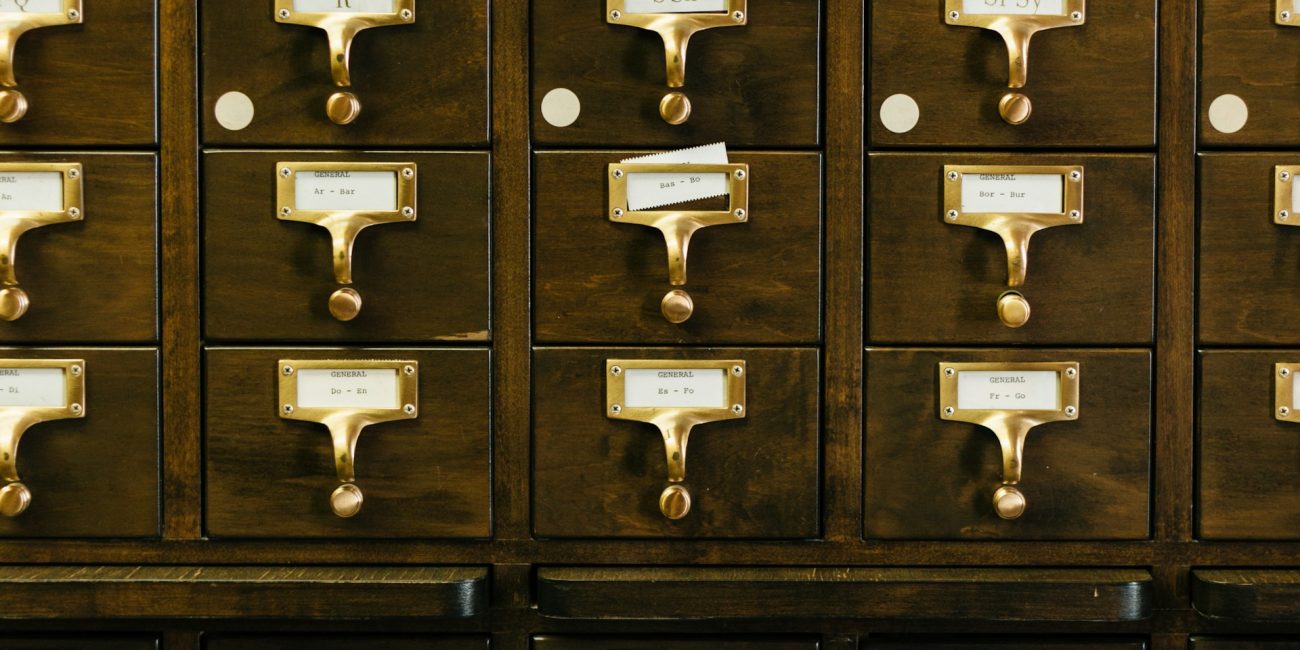 close-up photography of brown wooden card catalog